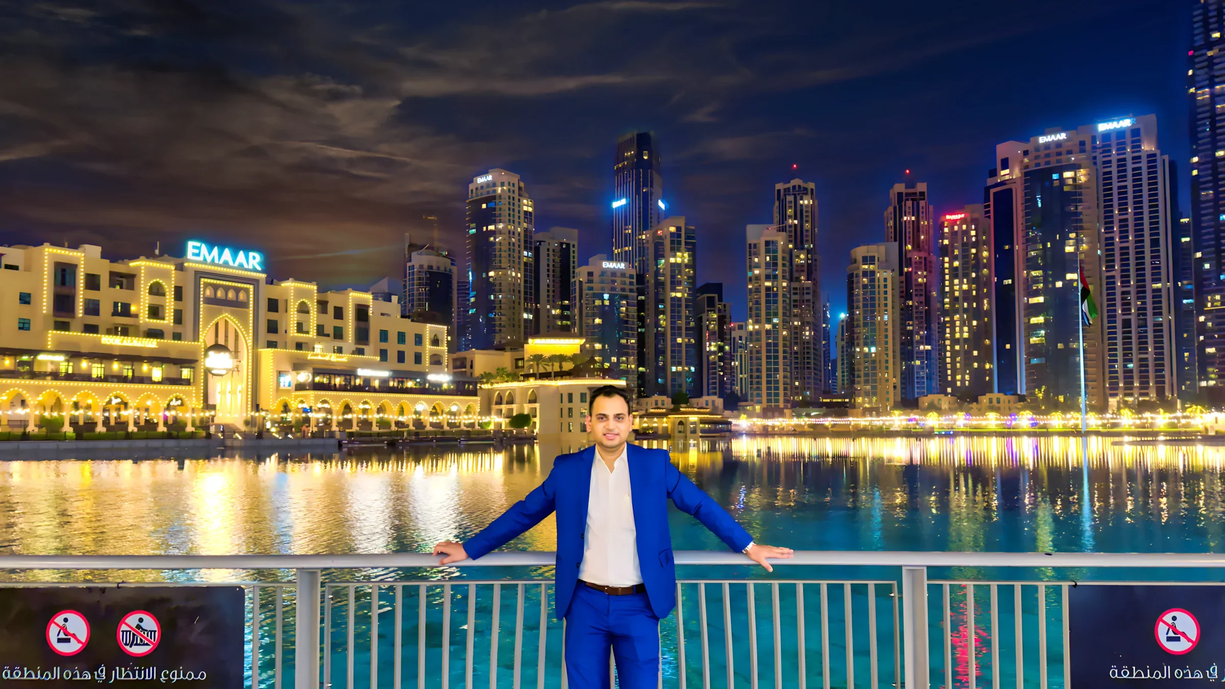 Lithvik Mukesh Sharma stands at a Dubai waterfront at night.