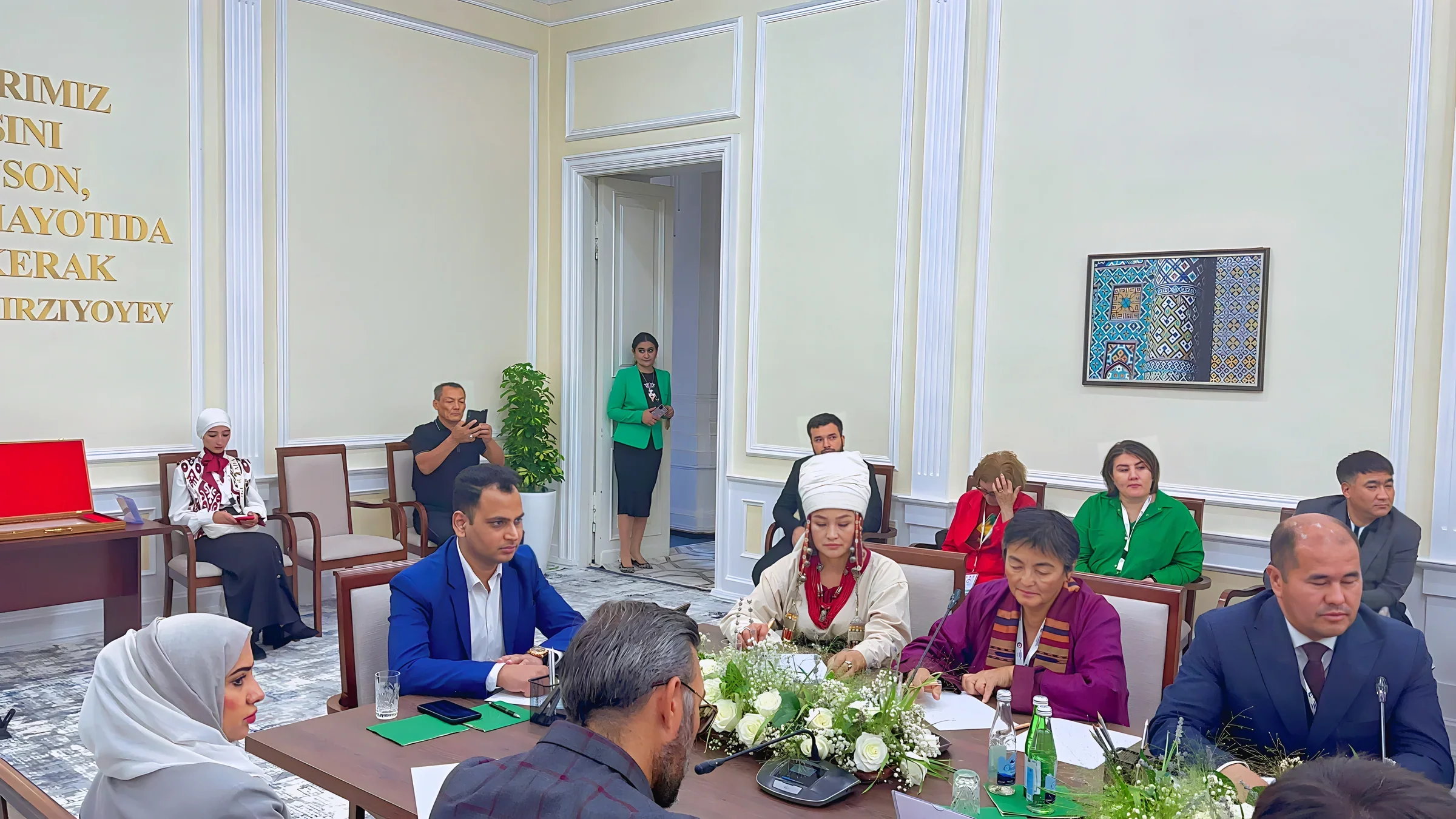 Lithvik Mukesh Sharma, Group CEO of CryptoMize, is photographed in a formal meeting at an official diplomatic setting in Uzbekistan. The formal meeting room has cream/beige walls, white decorative molding
