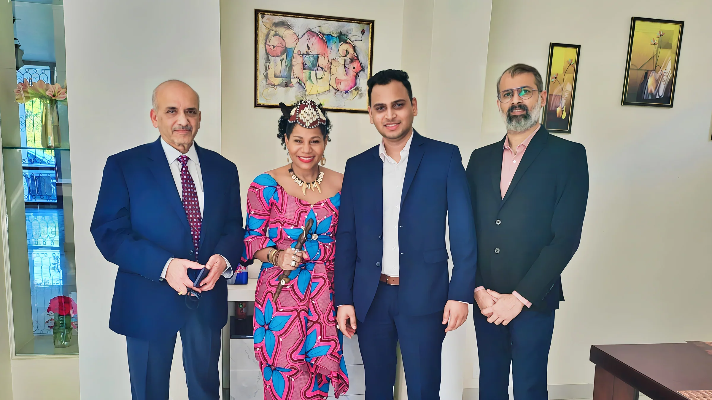 Lithvik Mukesh Sharma is photographed with Dr. Naveen Saxena (Chairman of Rusan Pharma Ltd.) and Queen Diambi at a celebration