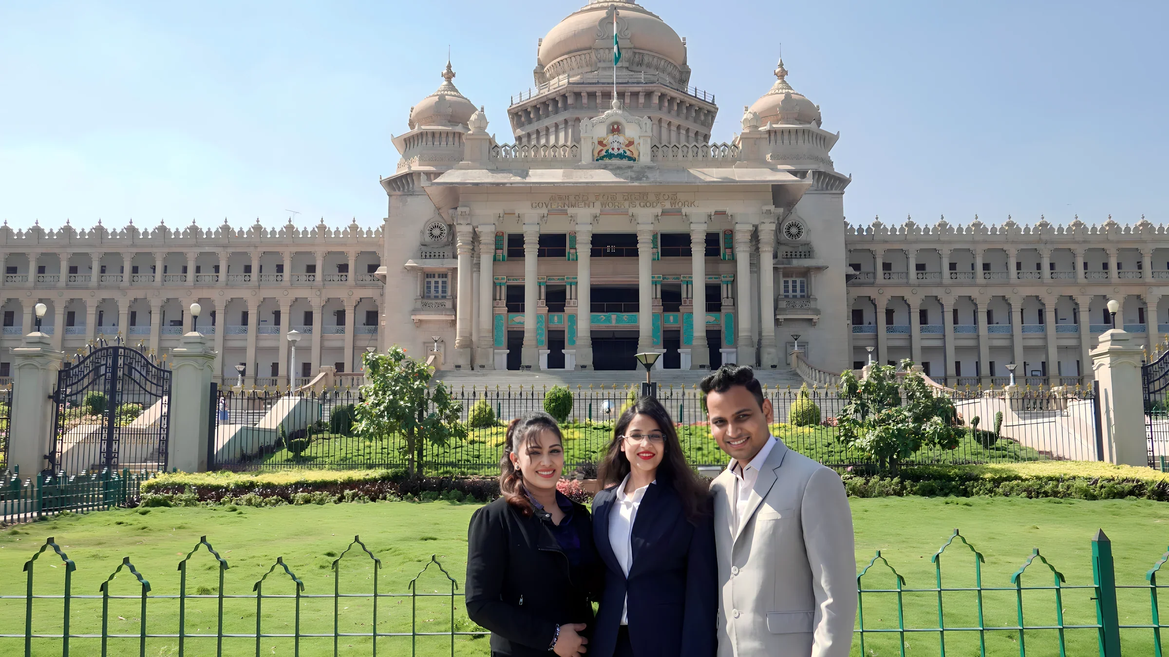 Lithvik Mukesh Sharma is photographed with Dr. Jyoti Kush and Ruksha at the Karnataka Vidhan Sabha building.